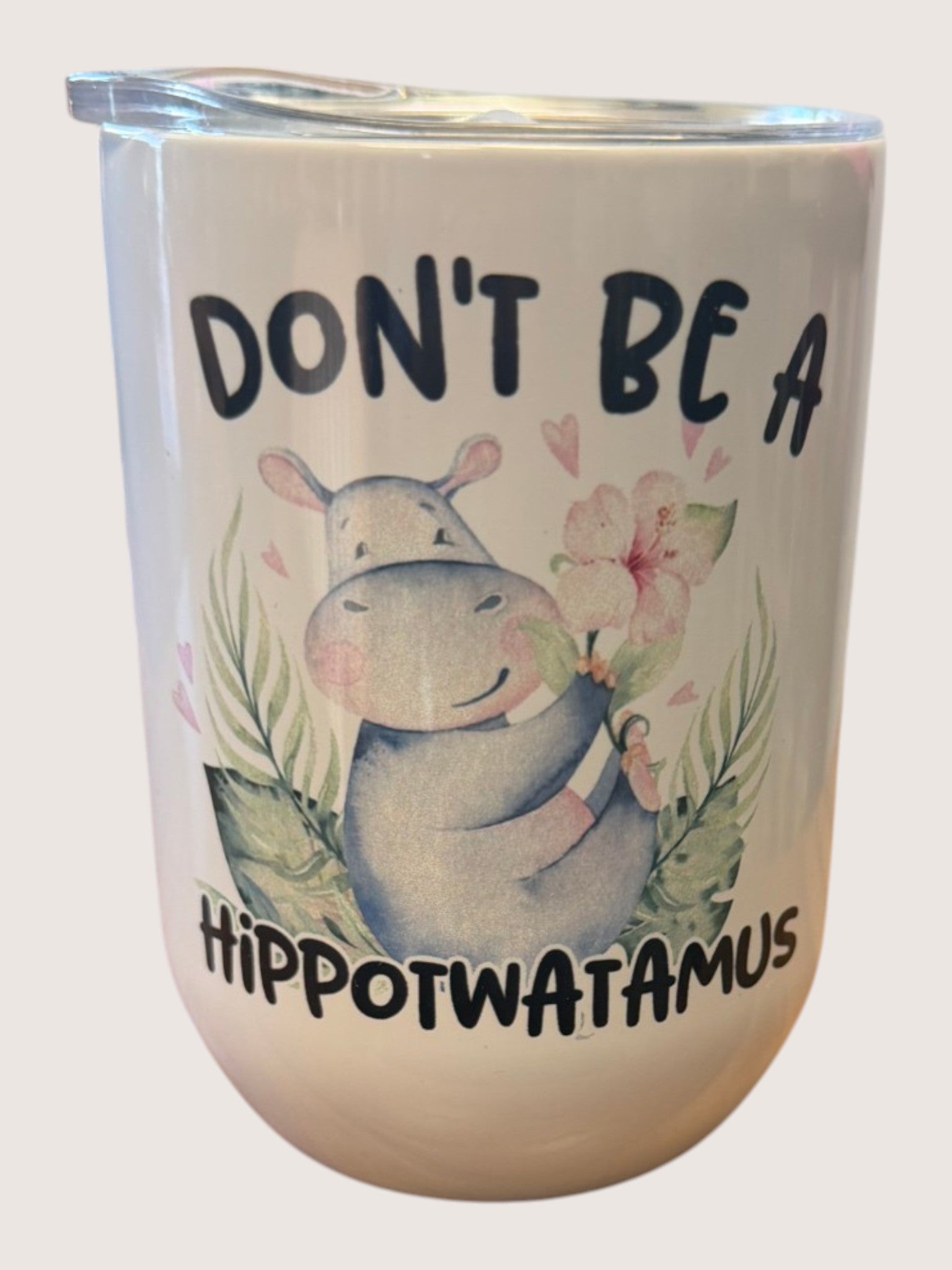 Tumbler with a hippo illustration and text on a white background