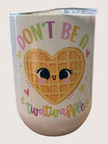 Tumbler with a waffle design and text on a plain background
