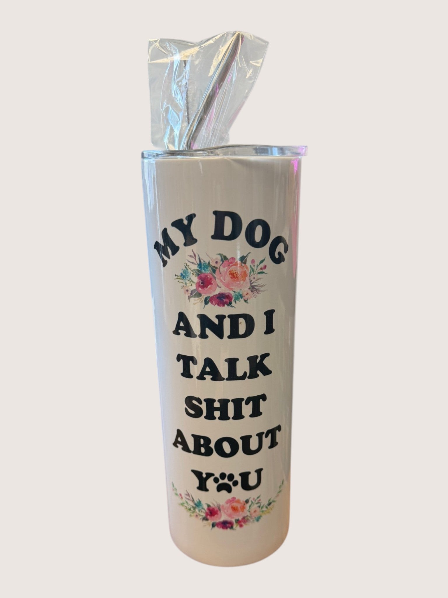Tumbler with text 'My dog and I talk shit about you' on a white background