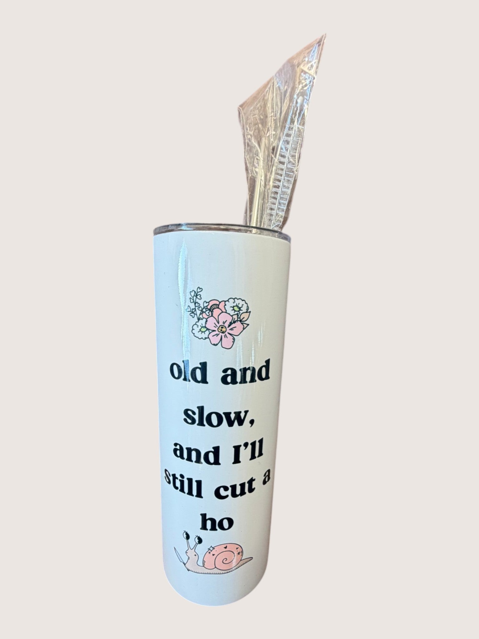 Tumbler with floral design and text on a white background