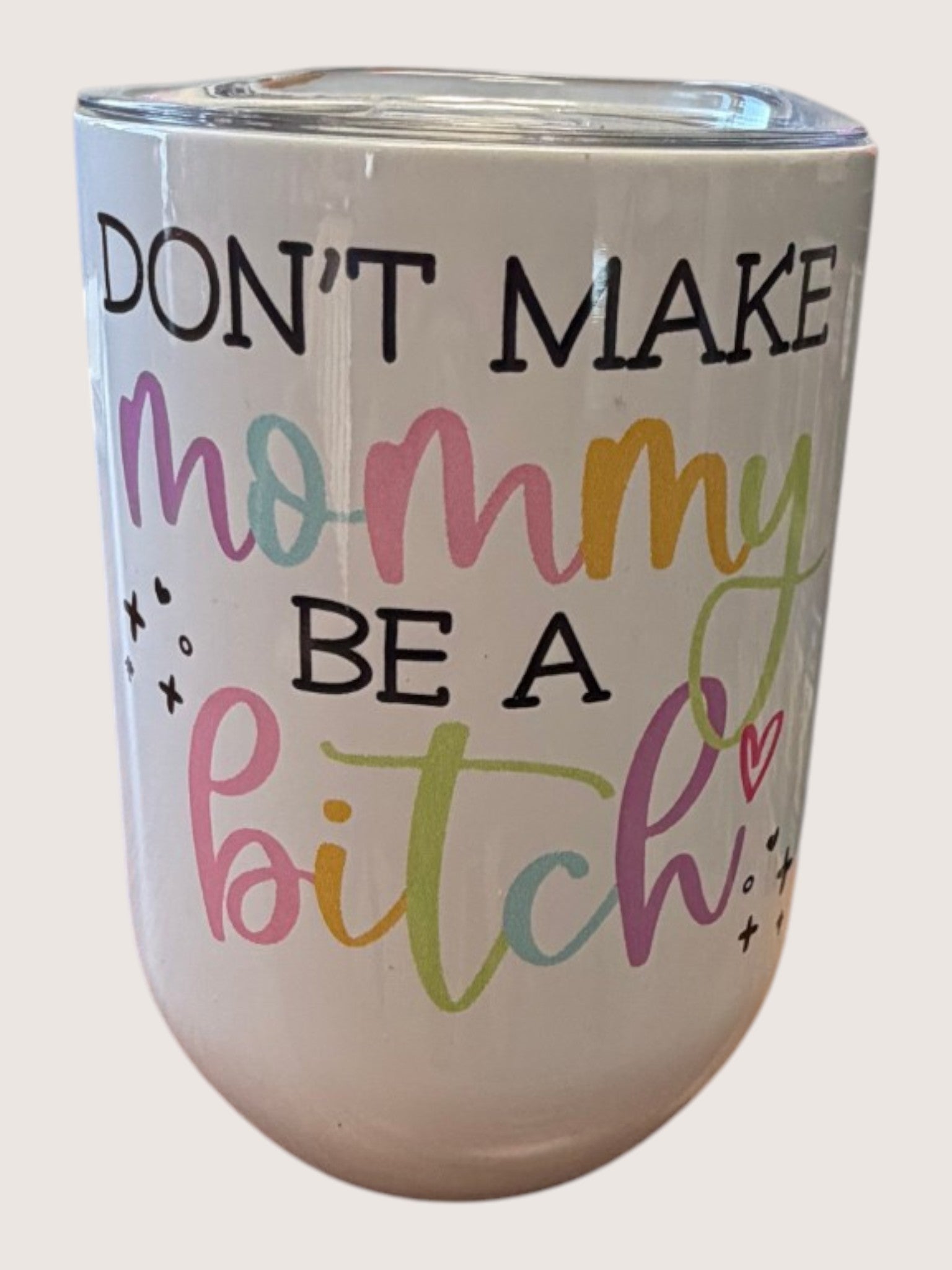 White tumbler with colorful text on a white background