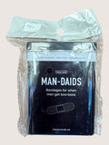 Packaged bandages labeled 'Man-Daids' with humorous text on a light background