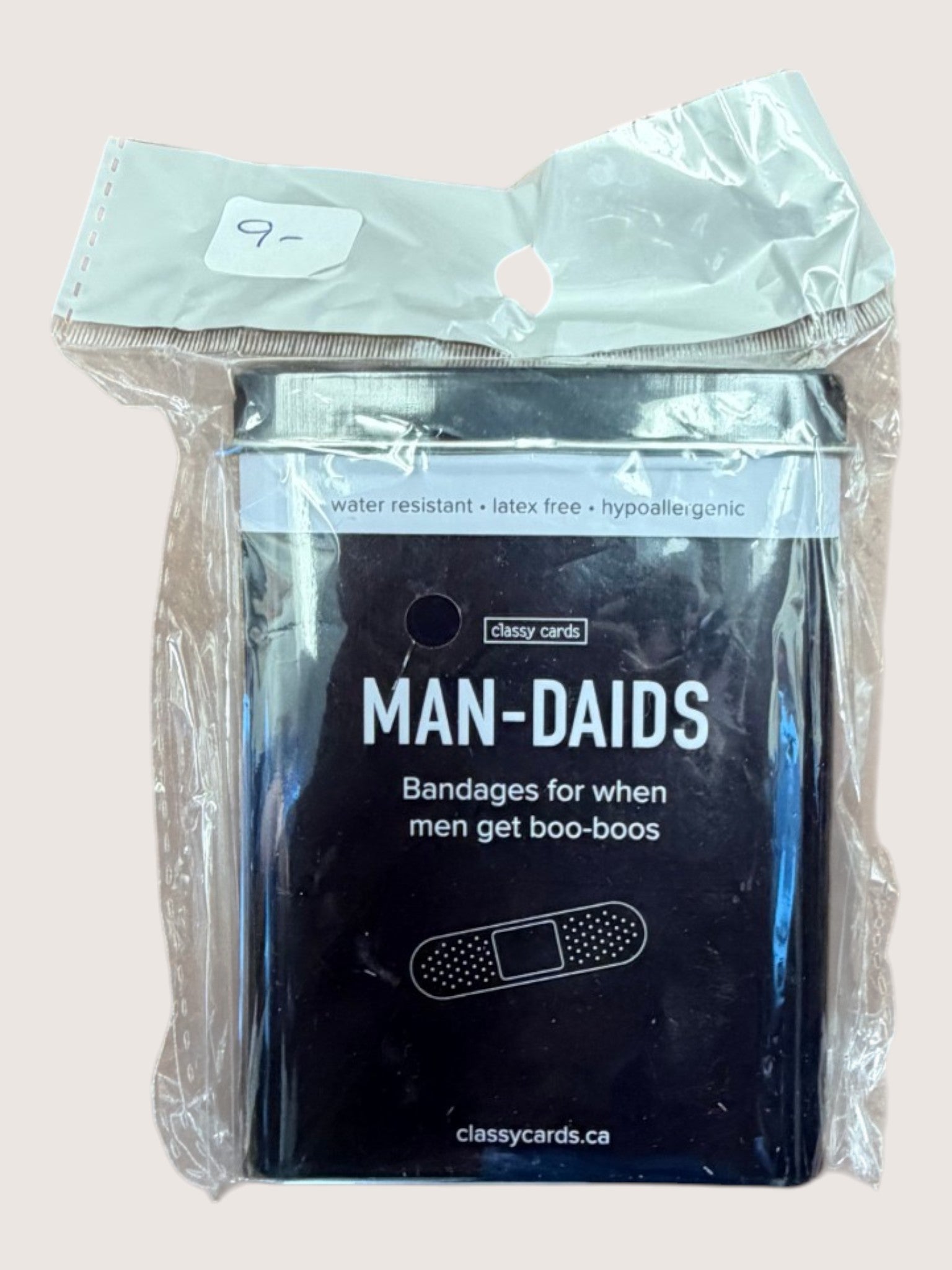 Packaged bandages labeled 'Man-Daids' with humorous text on a light background