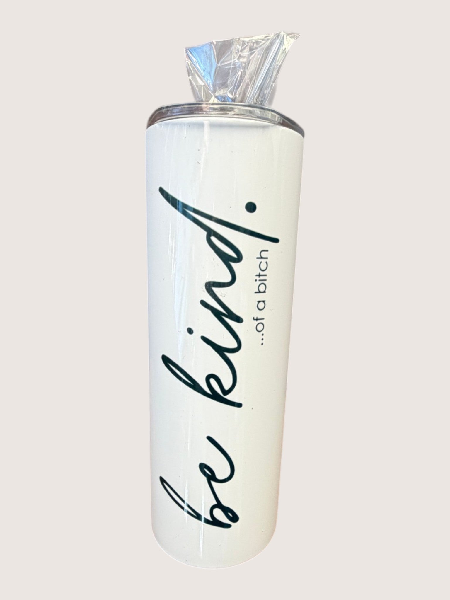Tumbler with 'be kind...of a bitch' text on a light gray background