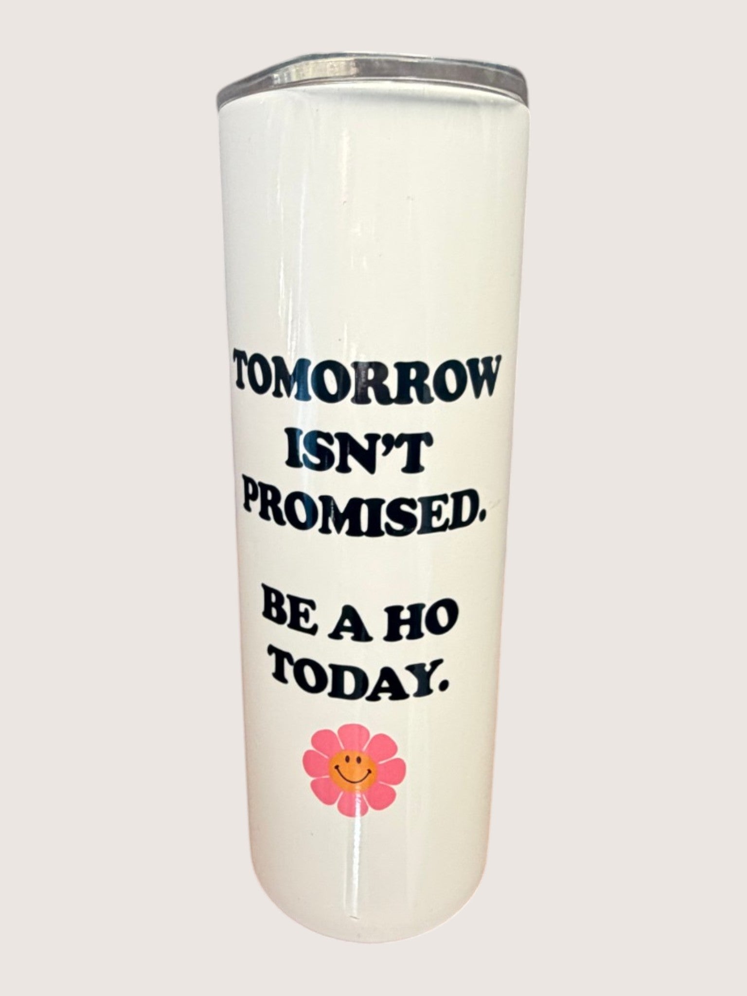 Tumbler with motivational quote and flower design on a white background