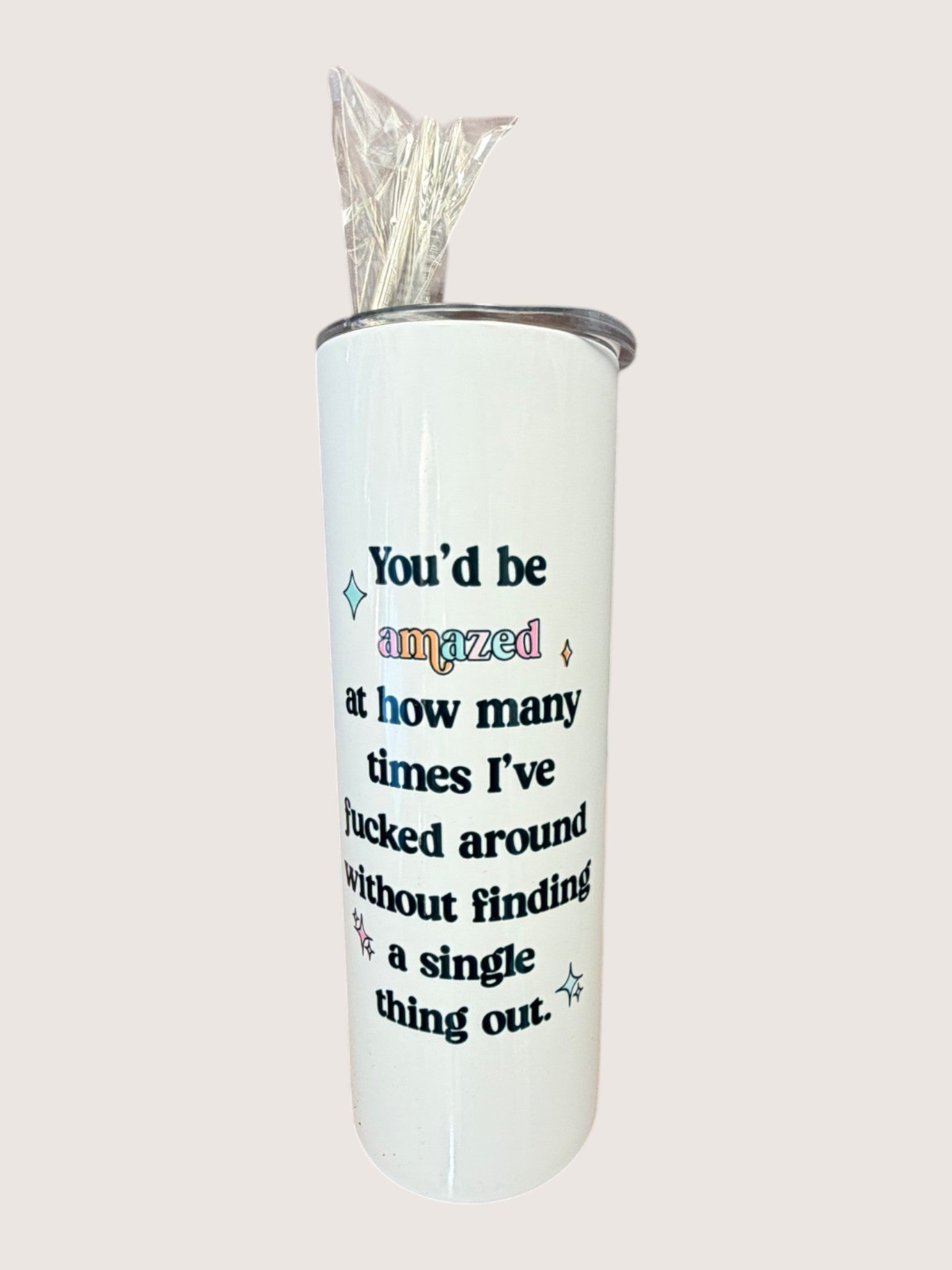 White tumbler with colorful text on a white background