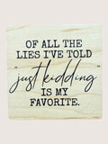 Wooden Coaster with humorous text 'Of all the lies I've told, just kidding is my favorite.'