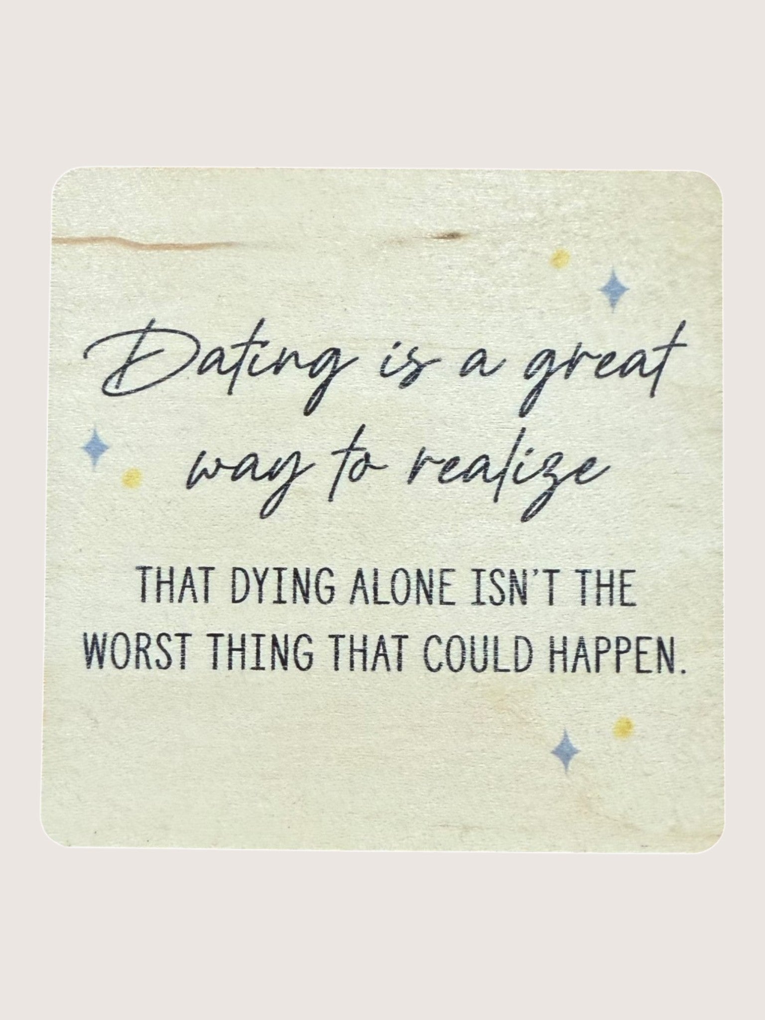 Wooden Coaster with a humorous quote about dating on a light background