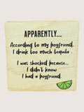 Wooden coaster with humorous text about drinking tequila and a lime graphic on a light background