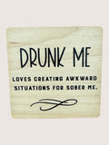 Wooden coaster with humorous text on a light background