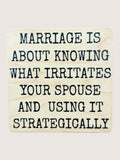 Wooden coaster with humorous quote about marriage on a light background