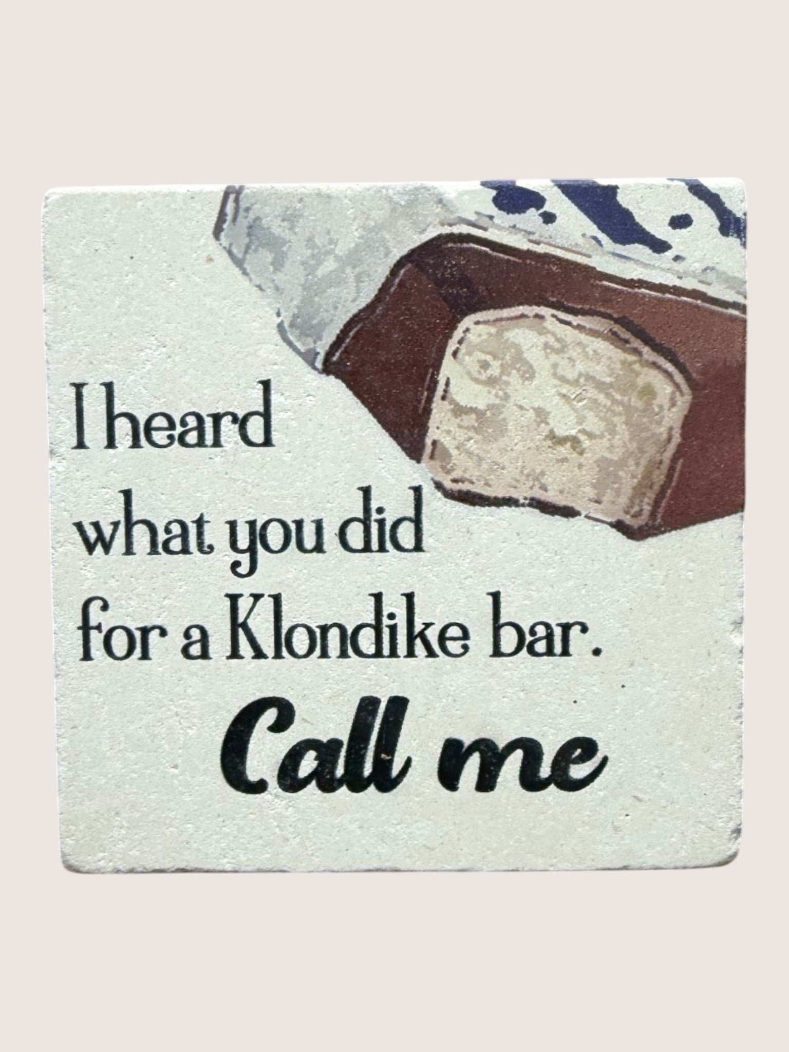 Coaster with a Klondike bar illustration and humorous text on a light gray background