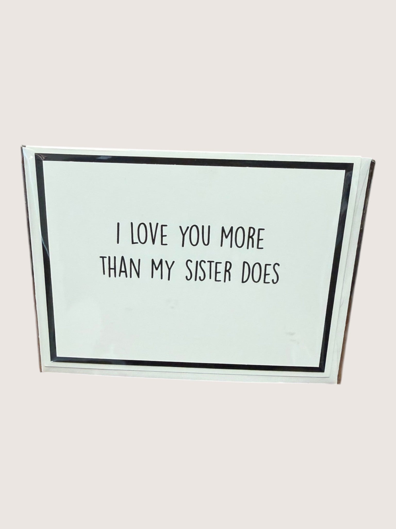 Card with text 'I love you more than my sister does' on a light background