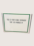 Card with text 'This is your yearly reminder that you married up' on a white background