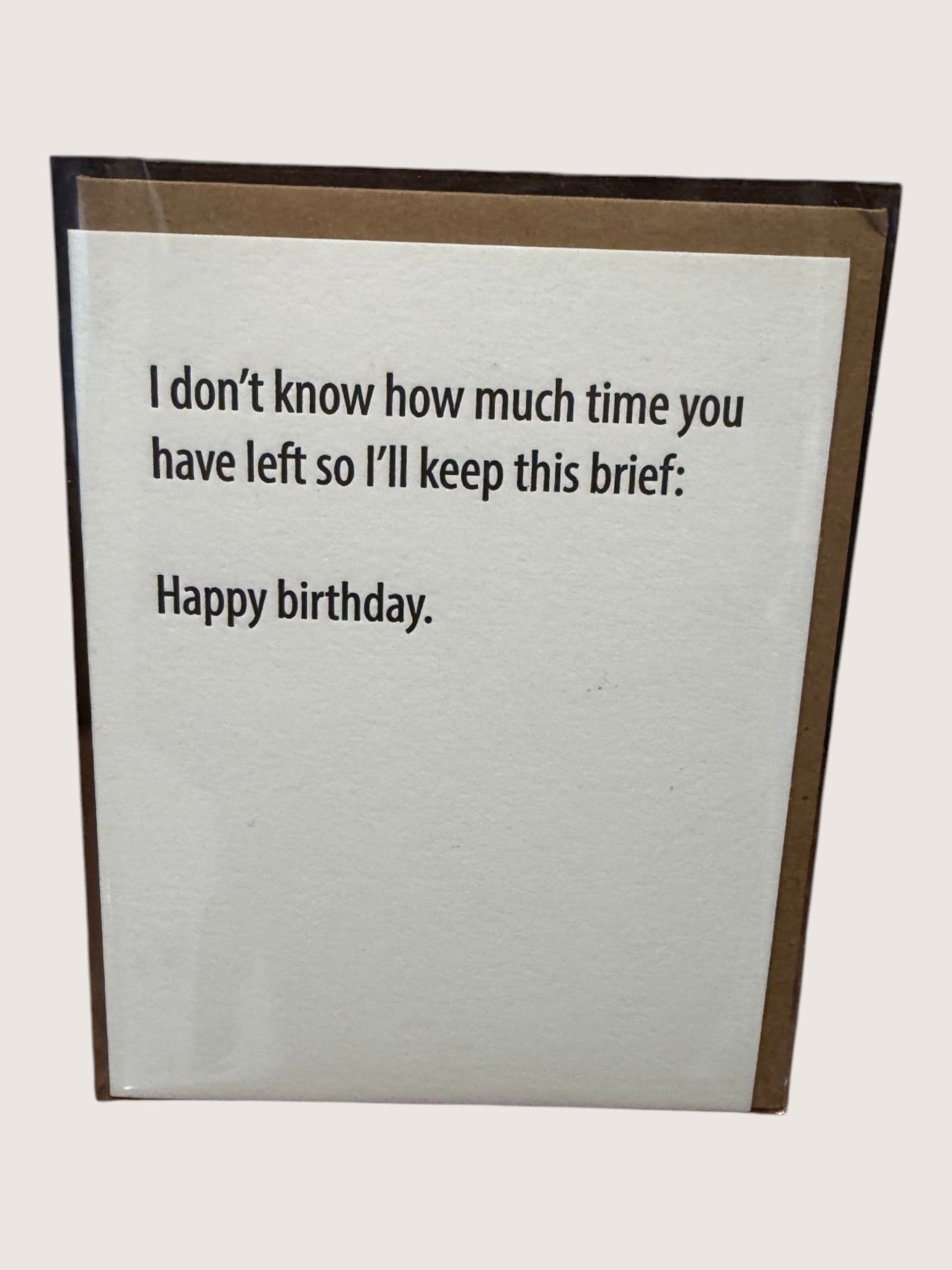 Birthday card with humorous text on a plain background