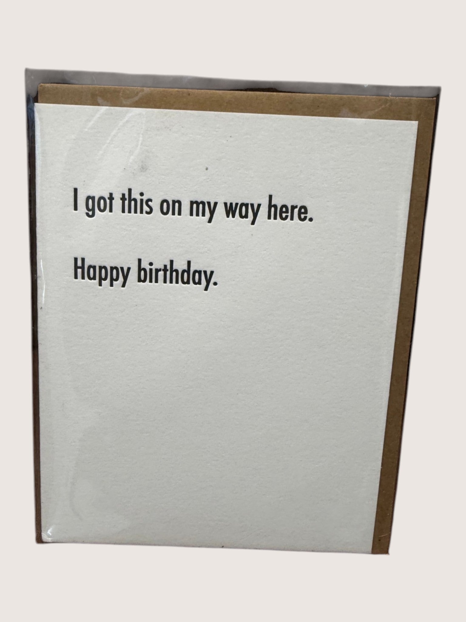 Birthday card with humorous text on a plain background