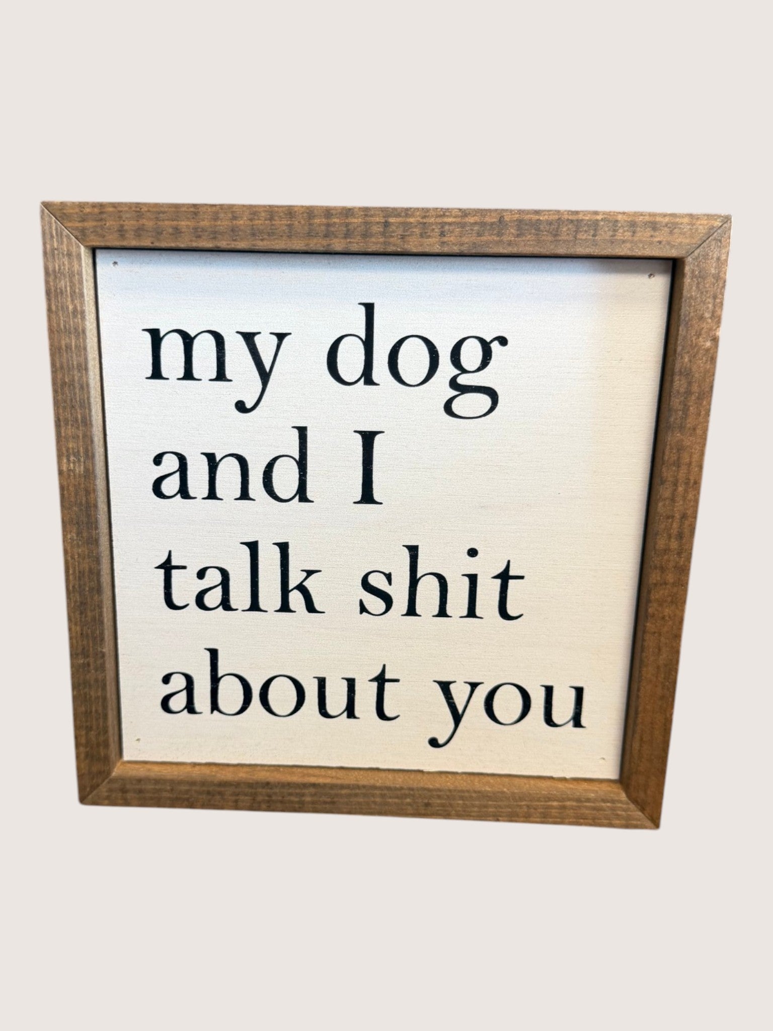 Wooden-framed sign with text 'my dog and I talk shit about you' on a white background