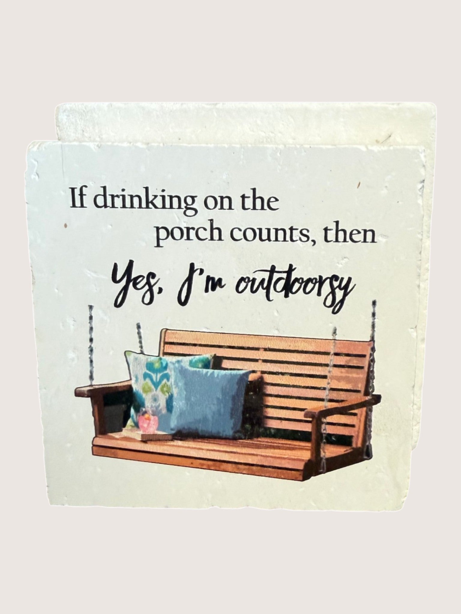 coaster with Wooden porch swing with pillows and humorous text on a light background