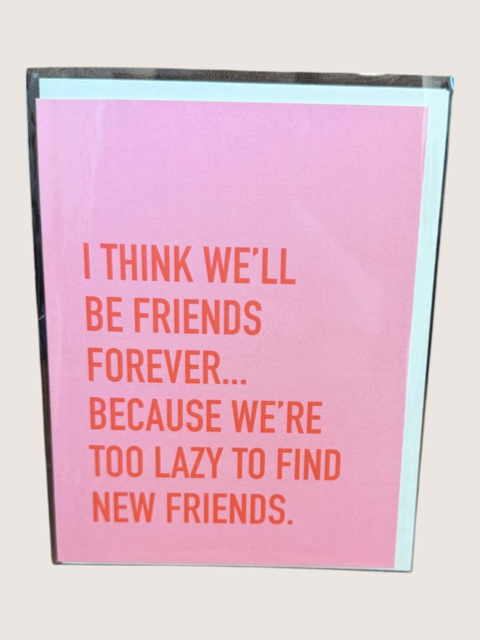 Pink card with red text on a light gray background