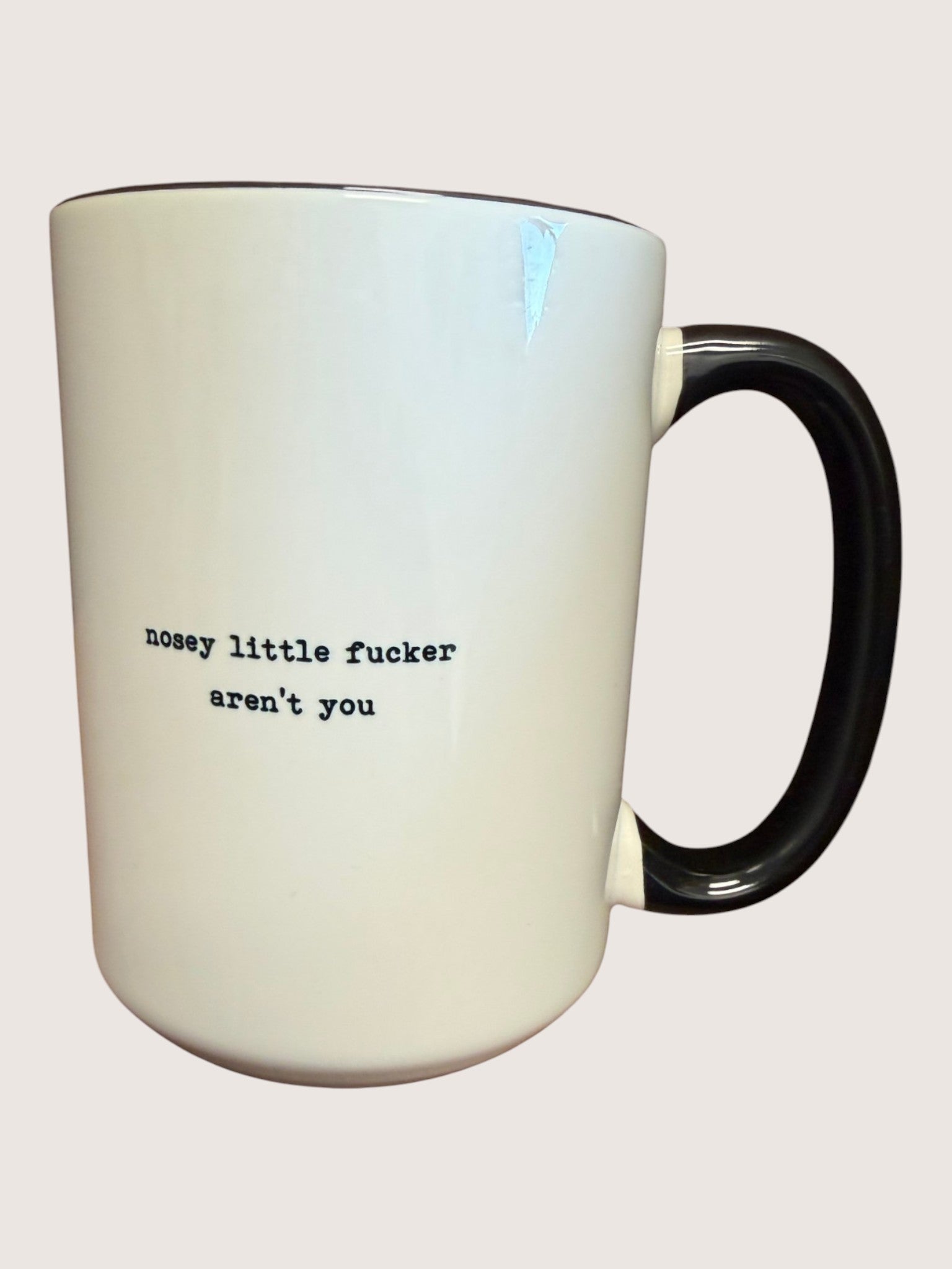 White mug with black text on a white background