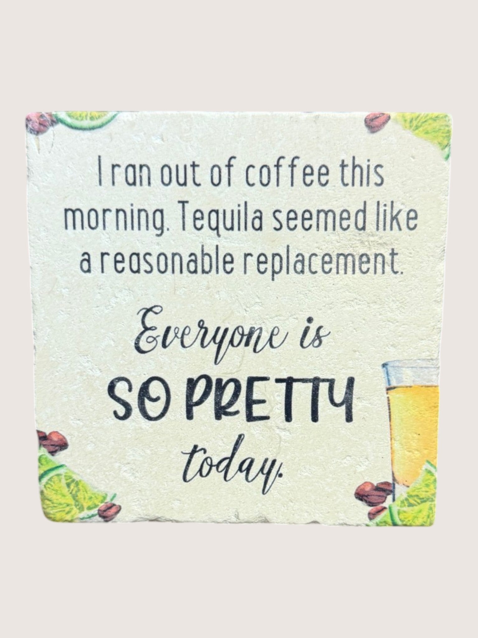 coaster with humorous text about coffee and tequila, featuring a lime and tequila bottle illustration.