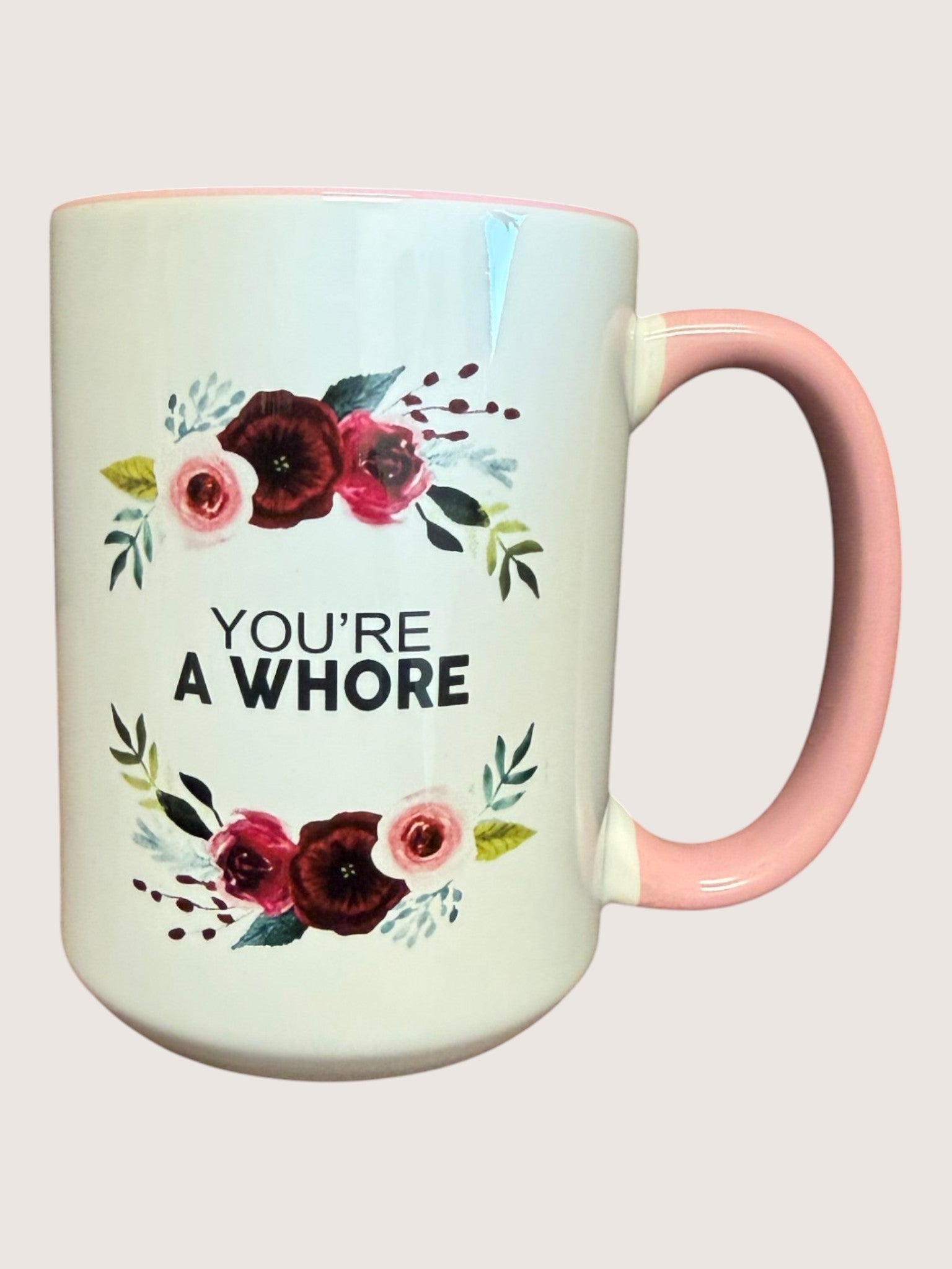 Mug with floral design and text on a light background