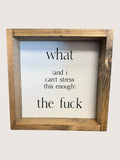 Wooden-framed sign with text on a plain background