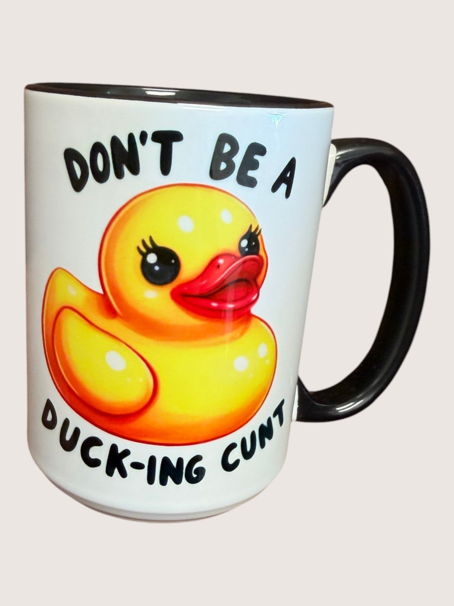 Mug with a rubber duck illustration and text on a white background