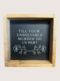 Wooden-framed sign with text 'Till your unsolvable murder do us part' on a black background