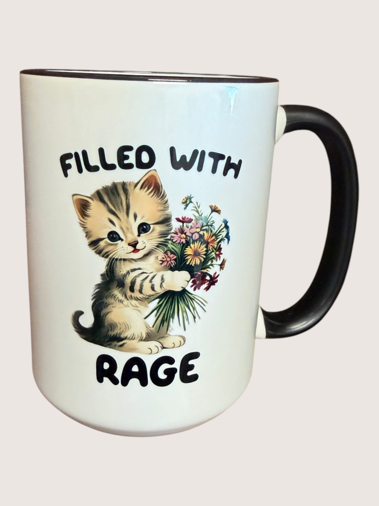 Mug with a kitten holding flowers and text 'Filled with Rage' on a white background
