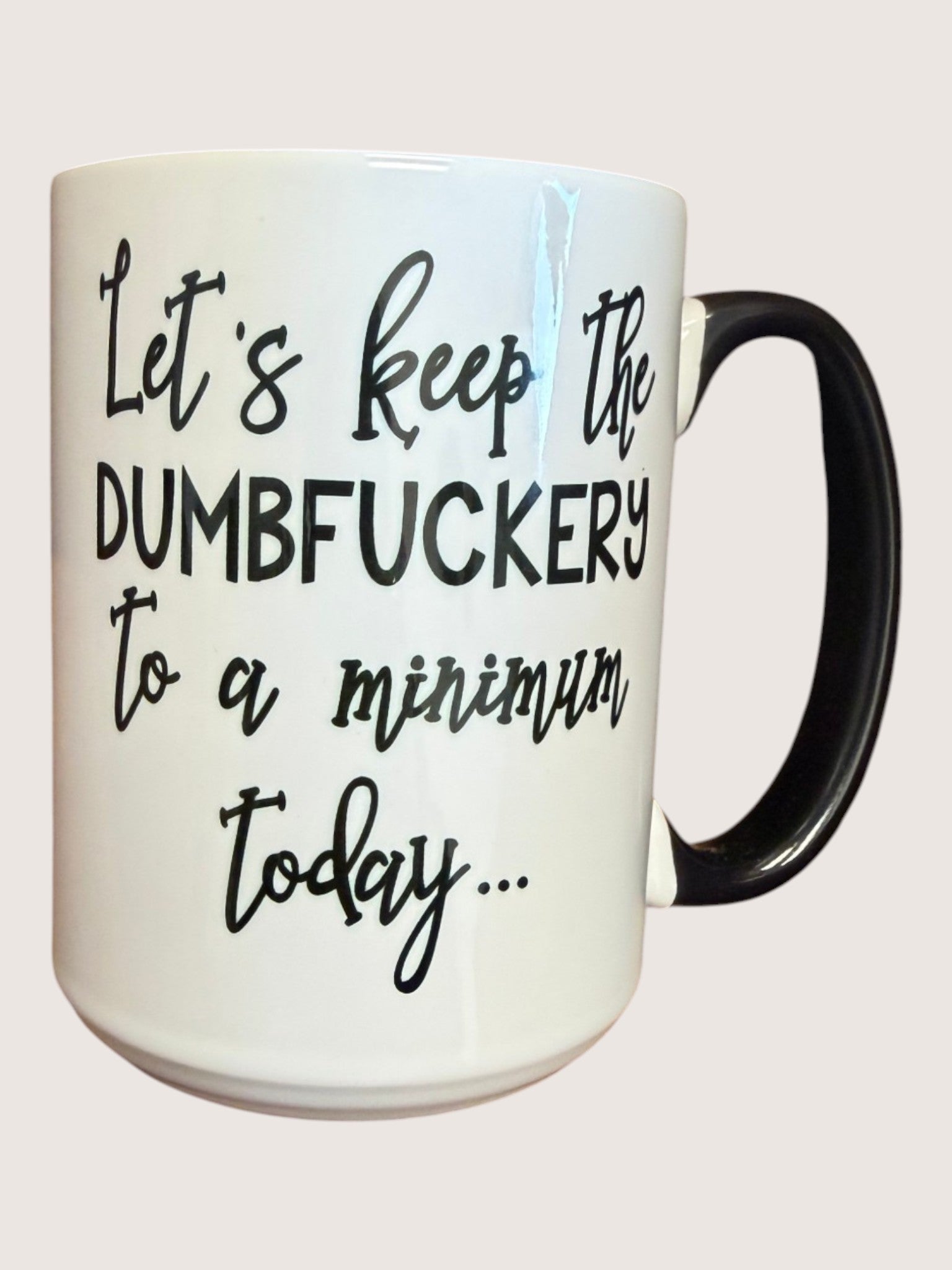 White mug with black text on a white background