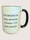 Mug with text 'I've decided to stop wearing glasses. I've seen enough.' on a light background