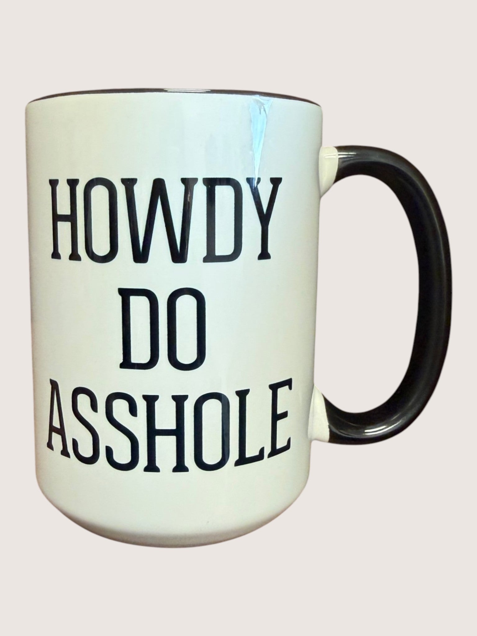 Mug with text 'HOWDY DO ASSHOLE' on a white background