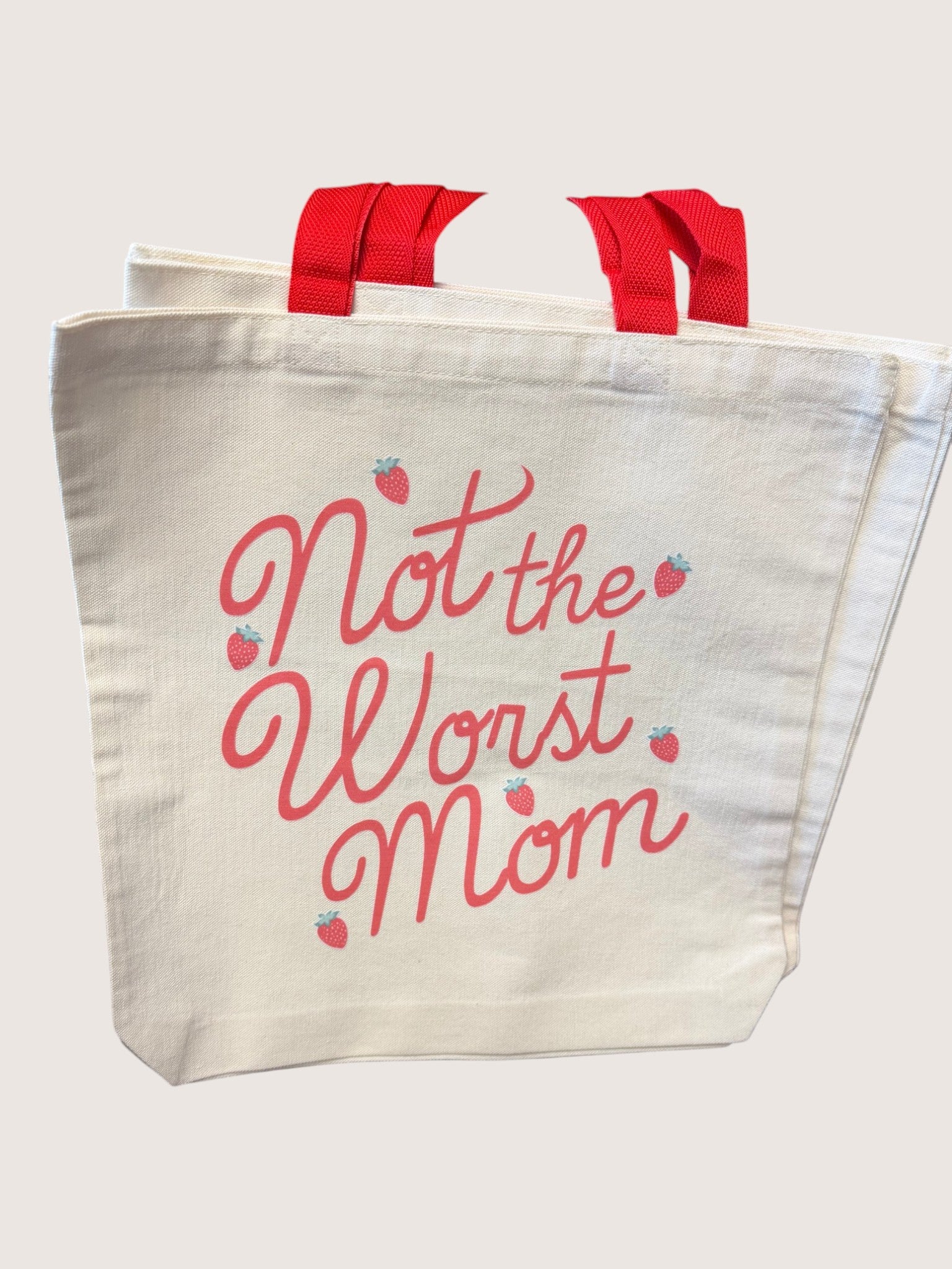 Tote bag with 'Not the Worst Mom' text and red handles on a white background