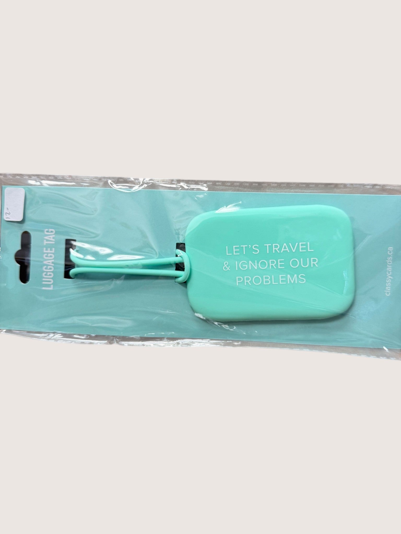 Turquoise luggage tag with text on a white background