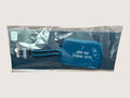 Blue luggage tag with text 'Are we there yet?' in packaging on a light gray background