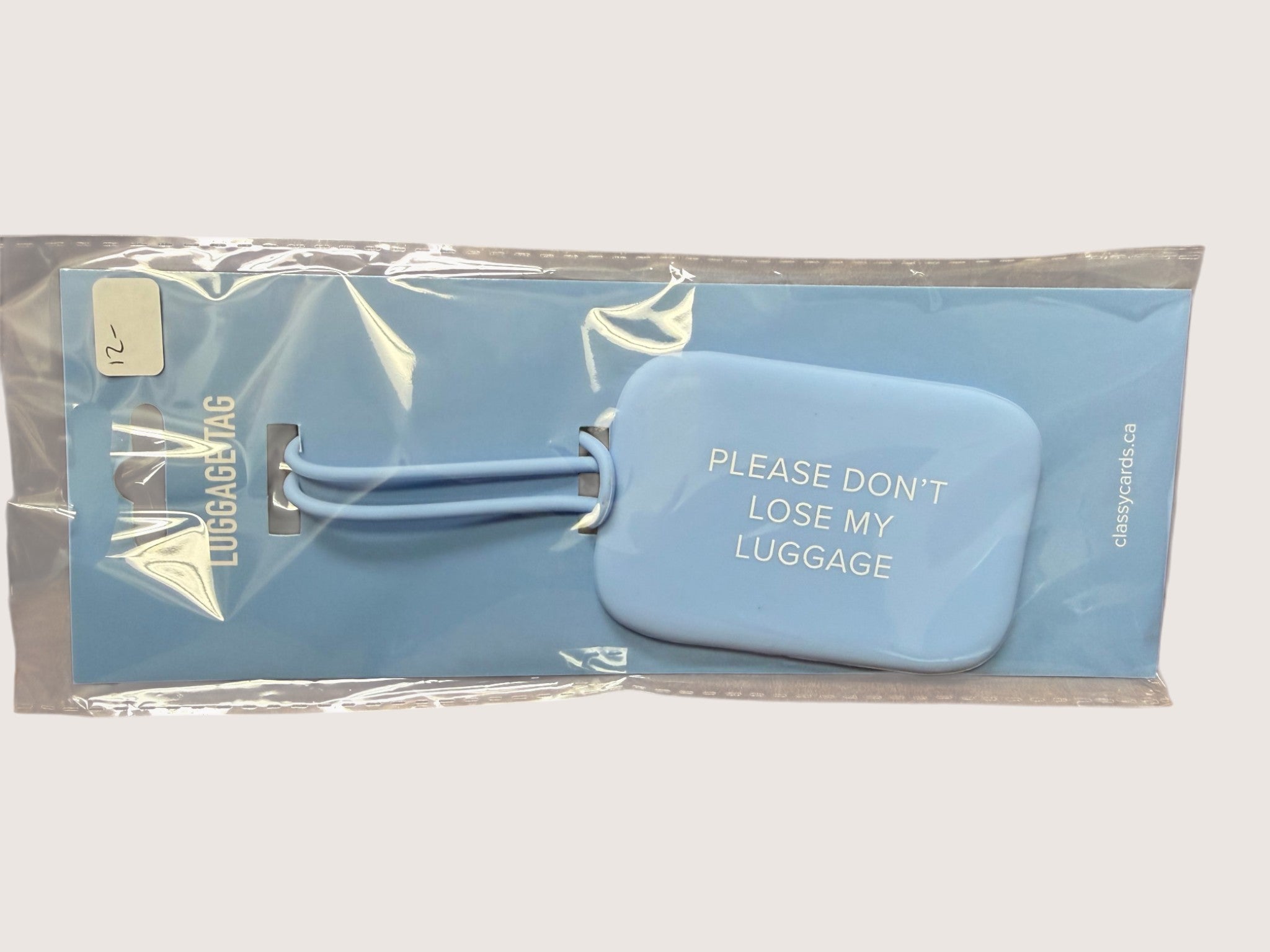 Blue luggage tag with 'Please don't lose my luggage' text in clear packaging