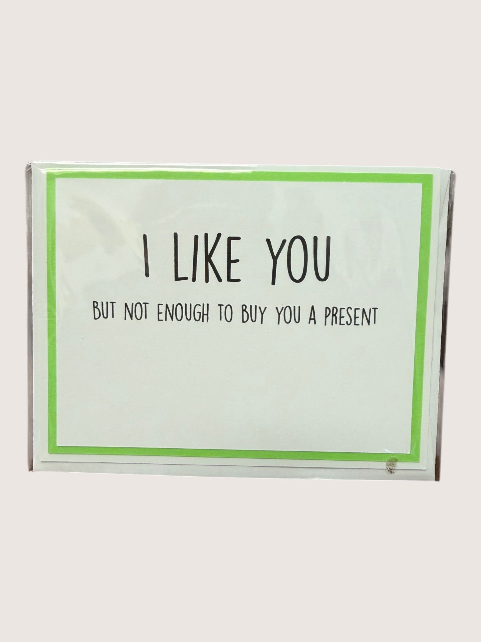 Card with text 'I LIKE YOU but not enough to buy you a present' on a white background