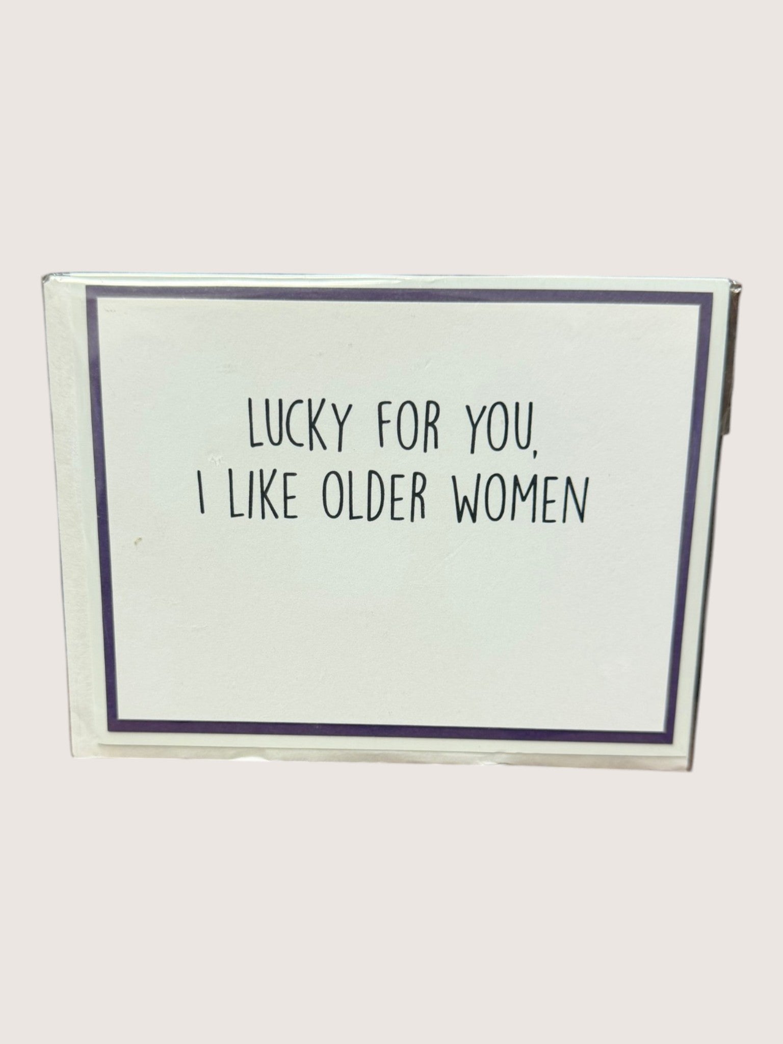 Card with text 'Lucky for you, I like older women' on a white background