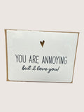 Card with text 'You are annoying but I love you!' and a heart symbol on a white background.