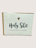 Card with text 'Holy Shit, you bought a house!' on a light green background