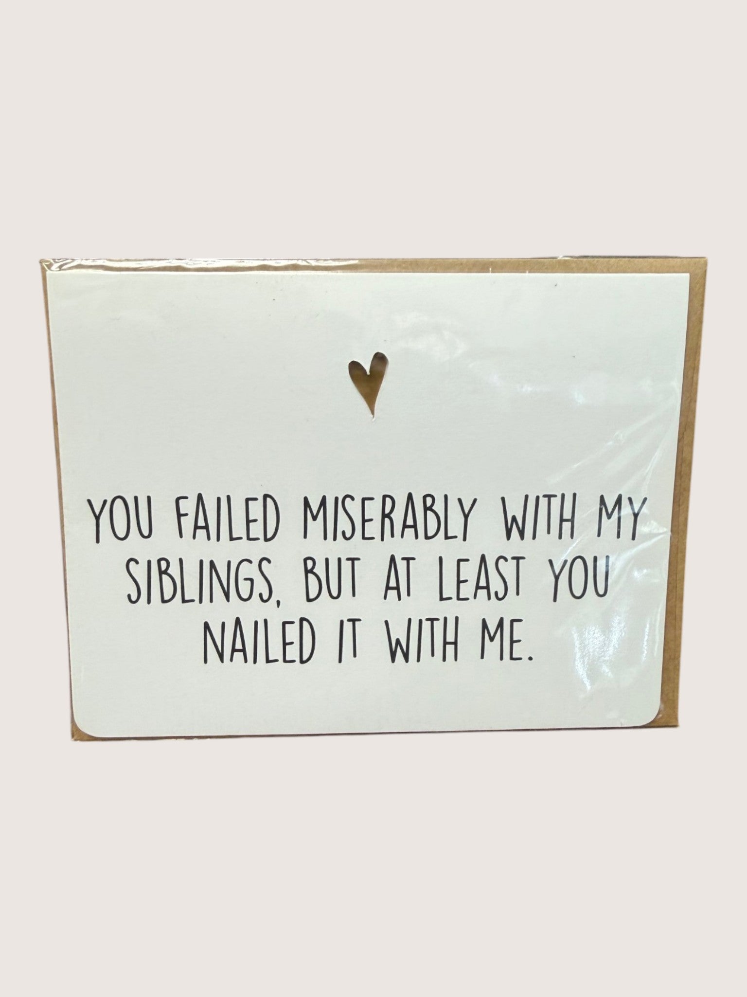 Card with humorous text and heart symbol on a light background