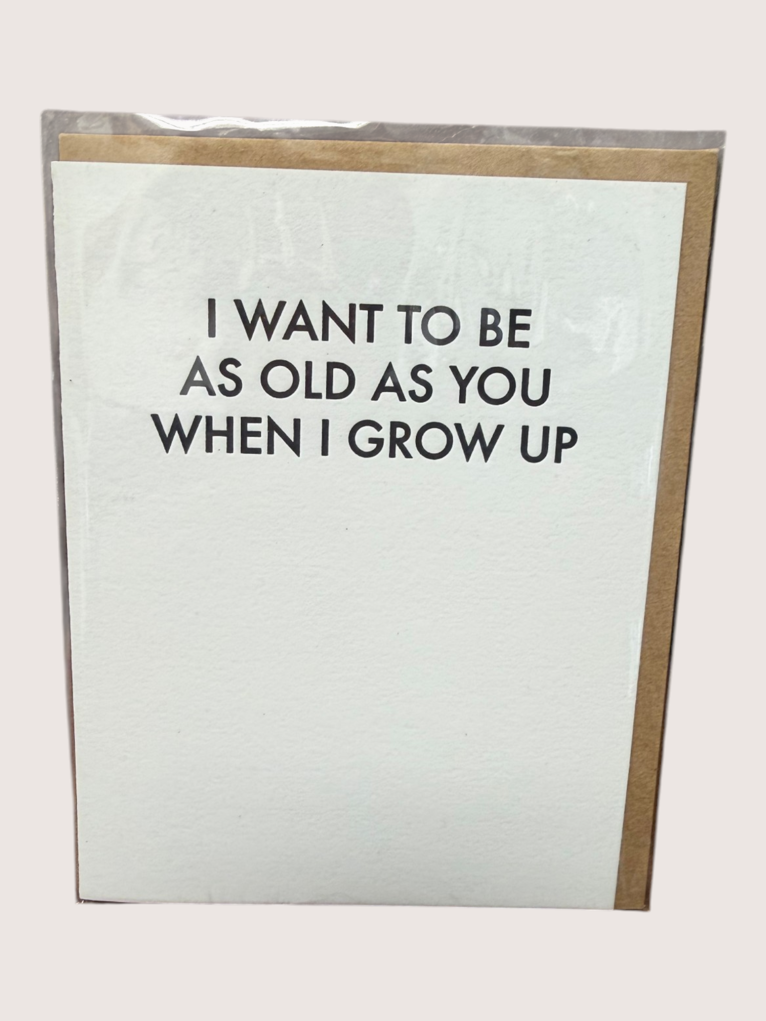 Card with text 'I want to be as old as you when I grow up' on a white background