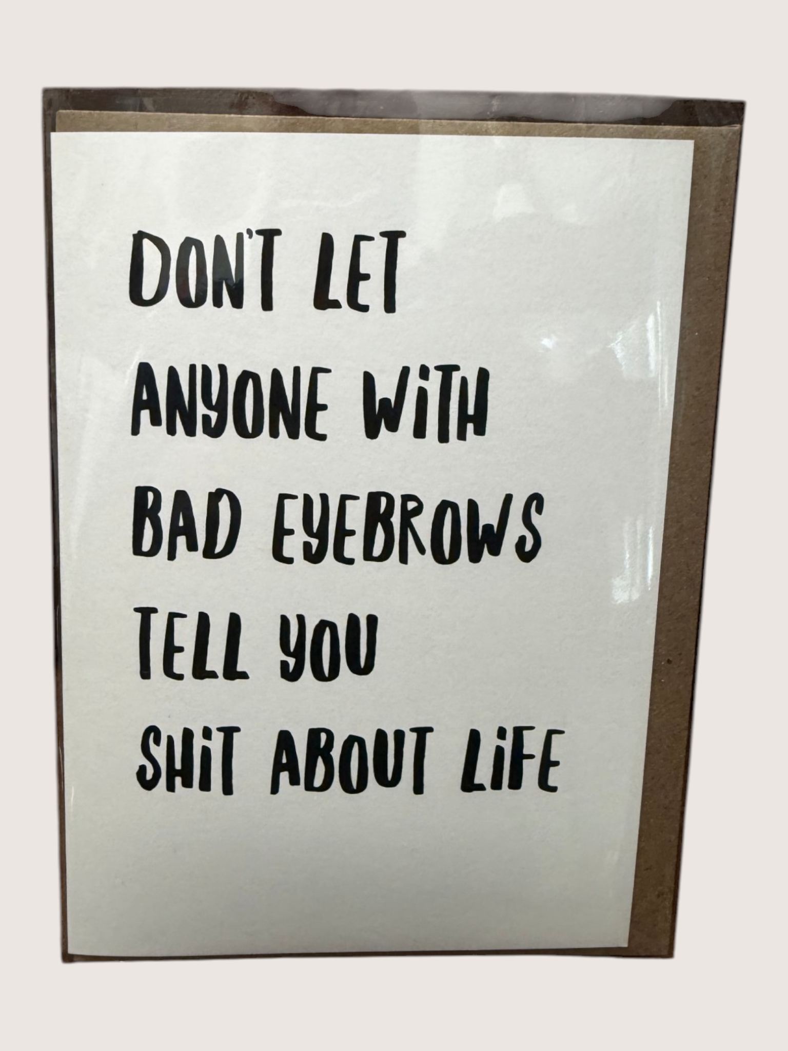 Card with humorous text about eyebrows and life on a white background
