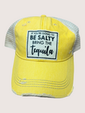 Yellow cap with text 'If you're going to be salty, bring the tequila' on a light gray background