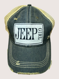Black and gold cap with 'Jeep Girl' logo on a beige background