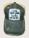Denim cap with a humorous text patch on a light gray background