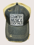 Distressed denim cap with 'Country Music & Cocktails' text on a light gray background