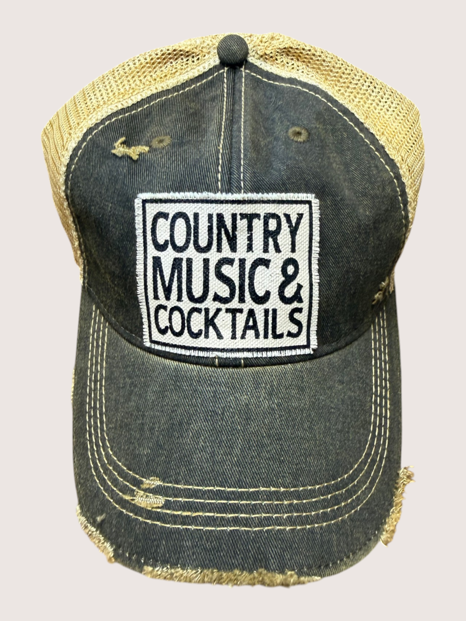 Distressed denim cap with 'Country Music & Cocktails' text on a light gray background
