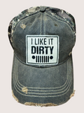Distressed denim cap with 'I Like It Dirty' patch on a light gray background